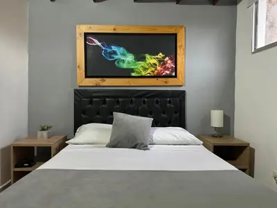 a bedroom with a bed and a painting on the wall at Gemas San Joaquin 1 in Medellín