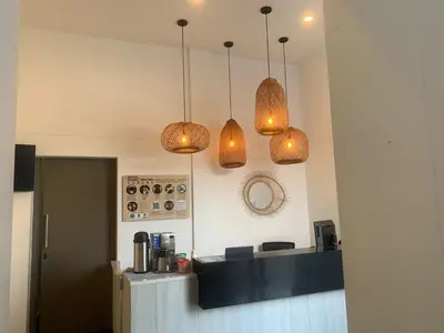 a kitchen with three lights hanging over a counter at Hotel Puerto Triunfo in Doradal