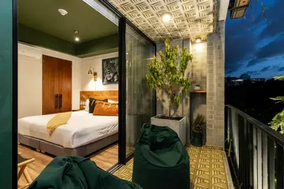 a bedroom with a bed and a balcony at Celestino Boutique Hotel & Spa in Medellín