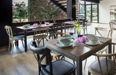 a dining room with wooden tables and chairs at Hotel Lagoon in Rionegro