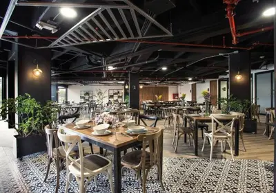 a restaurant with tables and chairs in a room at Hotel Lagoon in Rionegro