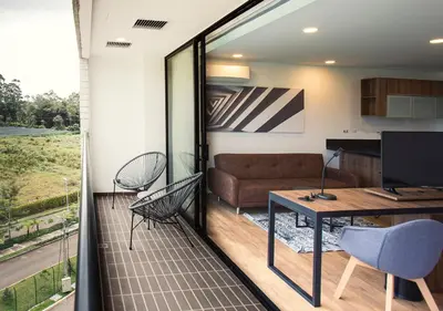 a living room with a couch and a table at Hotel Lagoon in Rionegro