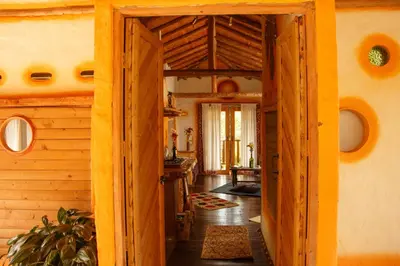 a hallway of a house with a wooden door at Hospedaje Solentiname in Medellín
