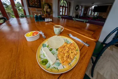 a plate of food on a wooden table at Ayenda Llanogrande Inn in Rionegro