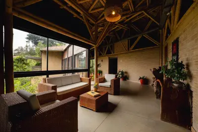 a living room with couches and chairs in a building at Cannúa Lodge Hotel in Marinilla