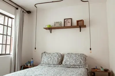 a bedroom with a bed with two pillows at ADN Algo de Nosotros - Malaika in Medellín