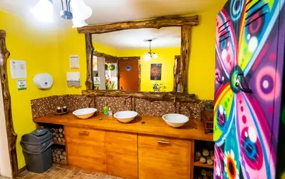 a bathroom with two sinks and a large mirror at ADN Algo de Nosotros - Malaika in Medellín