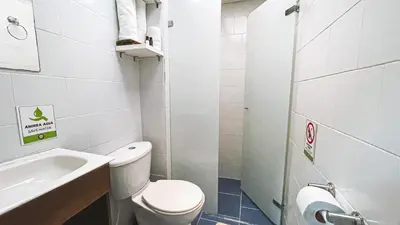 a small bathroom with a toilet and a sink at ADN Algo de Nosotros - Malaika in Medellín
