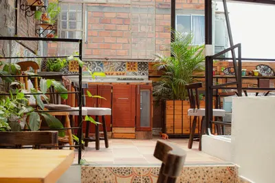 a patio with chairs and plants in a restaurant at ADN Algo de Nosotros - Malaika in Medellín