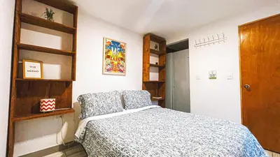 a bedroom with a bed and a book shelf at ADN Algo de Nosotros - Malaika in Medellín
