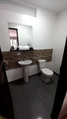 a bathroom with a sink and a toilet and a mirror at Hotel Anzea in Anserma