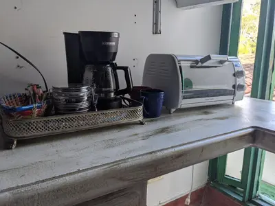 a counter top with a coffee maker and a toaster at Casa Finca Paititi in San Antonio de Pereira