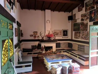 a living room with a couch and a fireplace at Casa Finca Paititi in San Antonio de Pereira