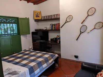 a bedroom with two tennis rackets on the wall at Casa Finca Paititi in San Antonio de Pereira