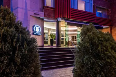 a facade of a building with stairs in front at Hotel Egina Medellin in Medellín