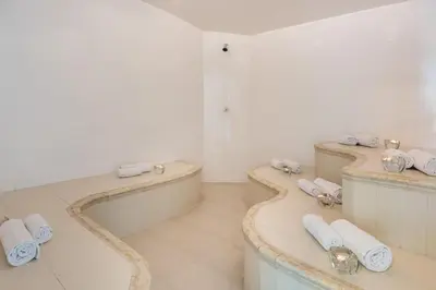a bathroom with two sinks and a bath tub at Hotel Egina Medellin in Medellín