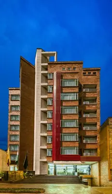 a tall building with a red stripe on it at Hotel Egina Medellin in Medellín