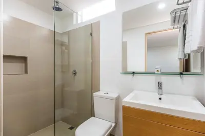 a bathroom with a toilet and a sink and a shower at Hotel Egina Medellin in Medellín