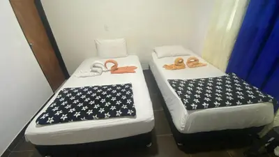 two beds in a room with an american flag sidx sidx sidx at Balcones de la Casona in Guatapé