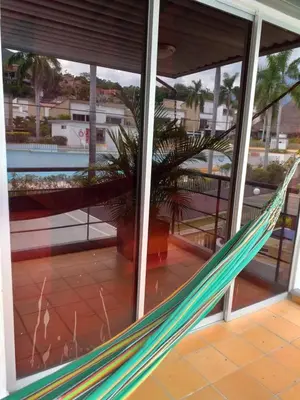 a hammock in a building with a palm tree at Cabaña Ciudadela Premium San Jeronimo in San Jerónimo