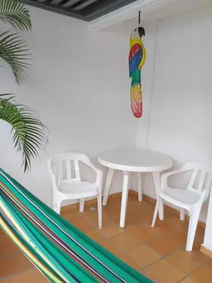 a white table and two white chairs and a table at Cabaña Ciudadela Premium San Jeronimo in San Jerónimo