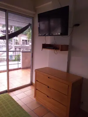 a room with a dresser and a flat screen tv at Cabaña Ciudadela Premium San Jeronimo in San Jerónimo