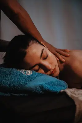 a woman laying on a bed with her hands on her head at Ecohotel Tierra de Agua in Cocorná