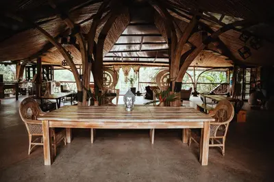 a large wooden table in a room with chairs at Ecohotel Tierra de Agua in Cocorná