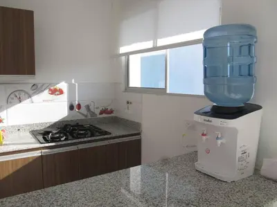 a kitchen with a blender on top of a refrigerator at Condominio Terrazas del Sol in Sopetran