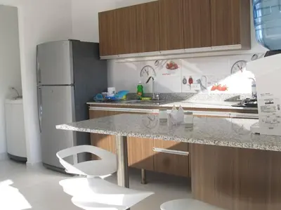 a kitchen with a counter and a refrigerator at Condominio Terrazas del Sol in Sopetran