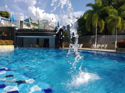 a fountain in the middle of a swimming pool at Condominio Terrazas del Sol in Sopetran