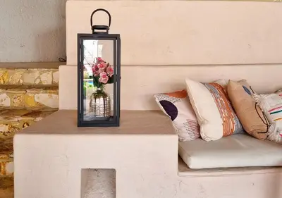 a table with a vase of flowers and a couch at Hotel Santa Barbara Colonial - Santa Fe de Antioquia in Santa Fe de Antioquia