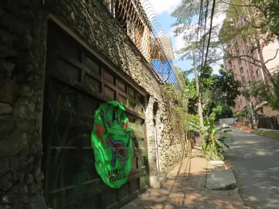 a wall with a green face painted on it at Arcadia Hostel Medellin in Medellín