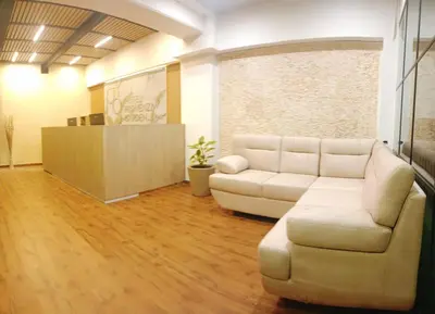 a living room with a couch and a table at Hotel Provenza Garden in Medellín