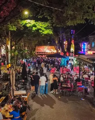 a crowd of people walking around a market at night at Hotel Provenza Garden in Medellín