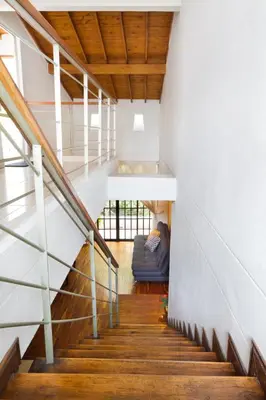 a staircase with a couch in the middle of a building at Casa Entera-Cerca a Mall La Central y Estación de Tranvía in Medellín