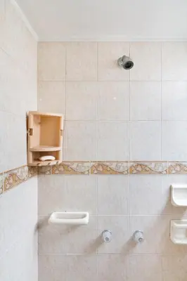 a tiled bathroom with a shower with a sink at Casa Entera-Cerca a Mall La Central y Estación de Tranvía in Medellín
