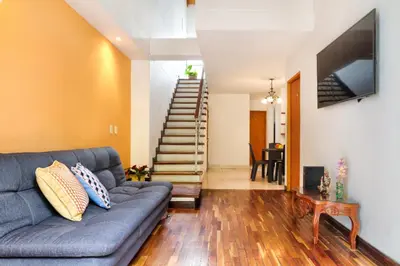 a living room with a couch and a staircase at Casa Entera-Cerca a Mall La Central y Estación de Tranvía in Medellín