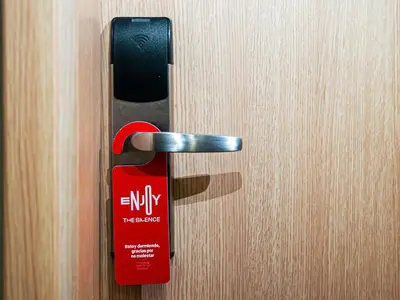 a black and red door handle on a wooden door at ibis Medellin in Medellín