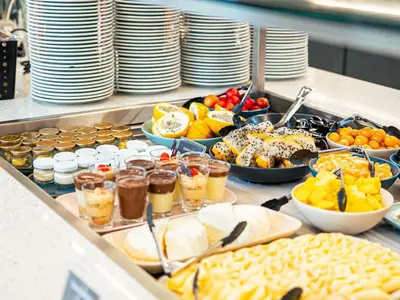 a buffet of food with plates and bowls of food at ibis Medellin in Medellín