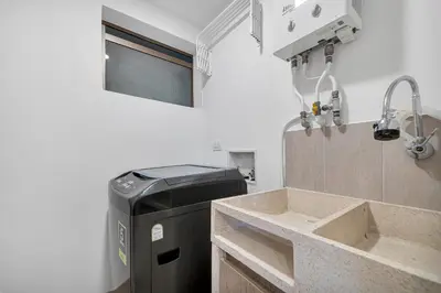 a small kitchen with a sink and a refrigerator at Aptos Alcazar Oviedo By HOUSY in Medellín