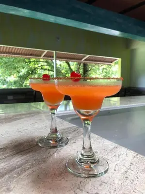 two cocktails sitting on top of a table at Hotel Jireh - San Carlos Ant in San Carlos