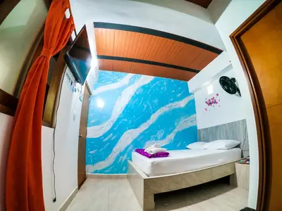 a small room with a mountain mural on the wall at Hotel Jireh - San Carlos Ant in San Carlos