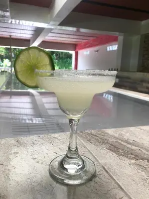 a margarita in a glass with a lime at Hotel Jireh - San Carlos Ant in San Carlos
