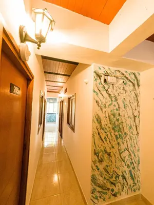 a hallway with a large painting on the wall at Hotel Jireh - San Carlos Ant in San Carlos