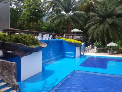 a swimming pool with blue water in a resort at Hotel el Tesoro in San Jerónimo