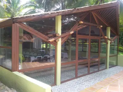 a large wooden pavilion with a dining area at Hotel el Tesoro in San Jerónimo