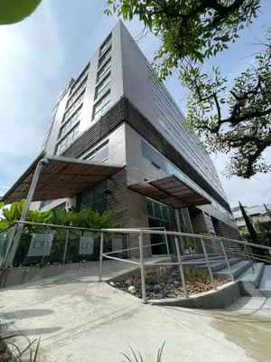 a tall building with a staircase in front of it at Hotel bh El Poblado in Medellín