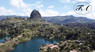 arial view of a lake with a mountain in the background at Finca Alejandria in Guatapé