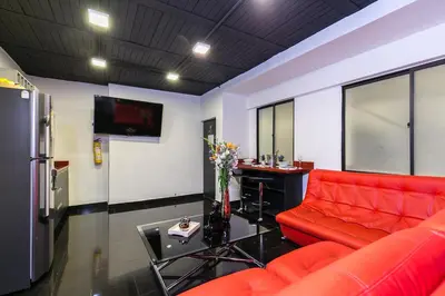 a living room with a red couch and a table at Provenza Lofts in Medellín